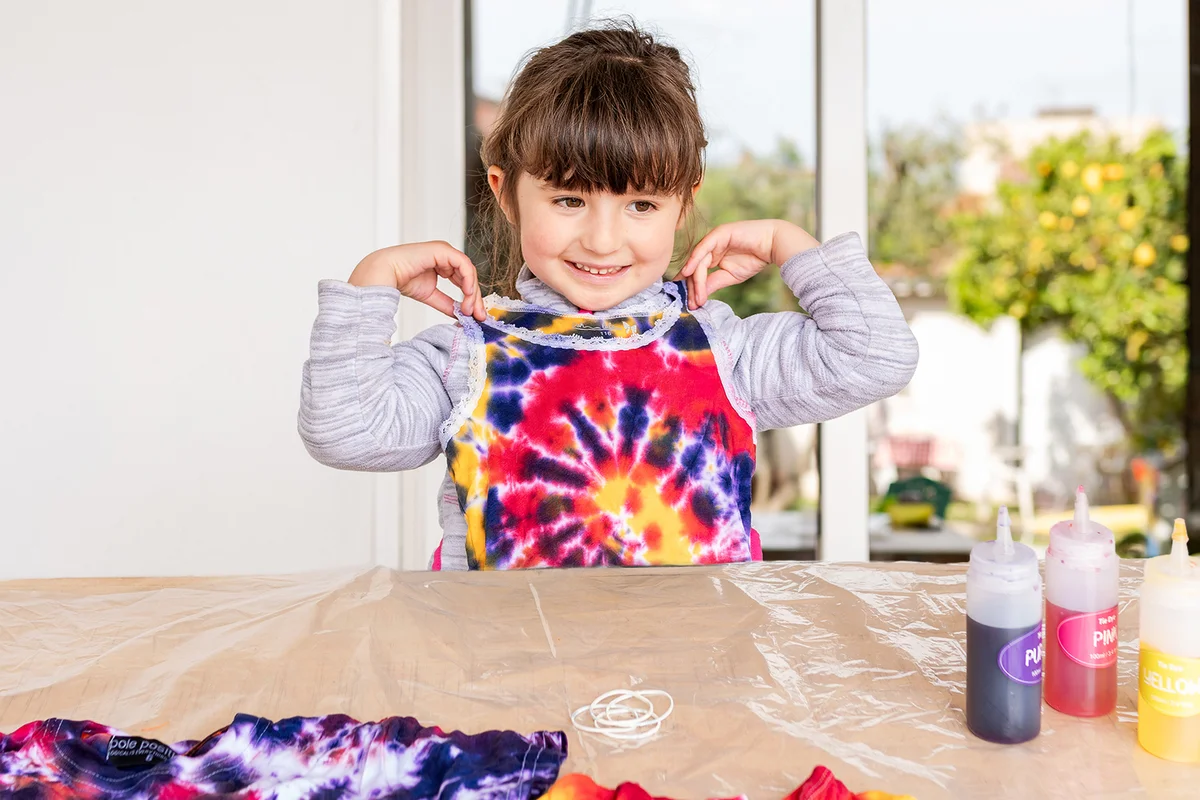 Girl making tie dye clothes at home