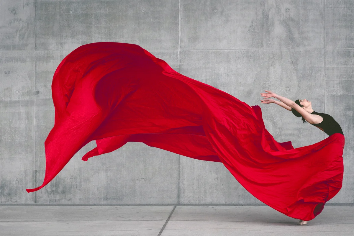 Female ballet dancer on pointes dancing with a red skirt