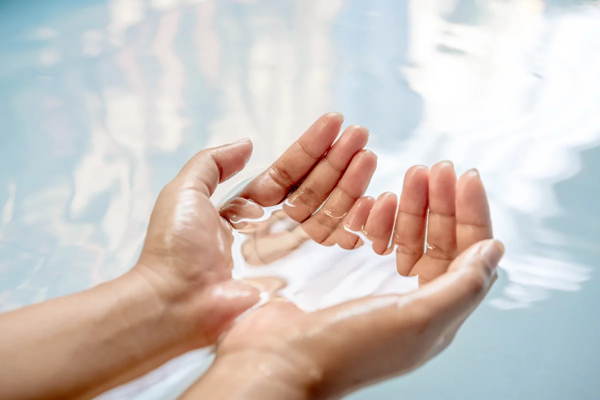 Cupped Hands Of Woman In Water