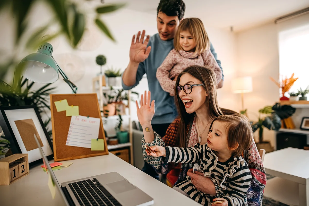 Happy family using laptop to talk with friends and family