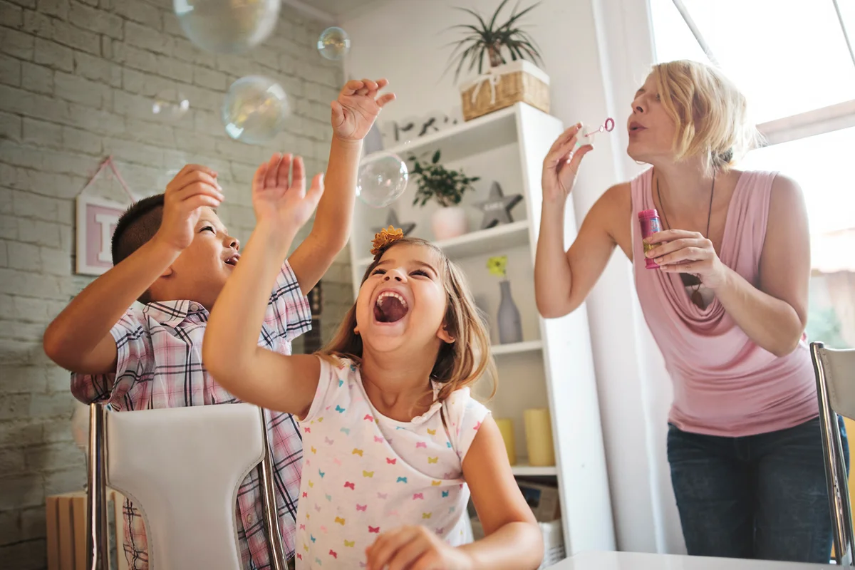 Mother and children blowing bubbles