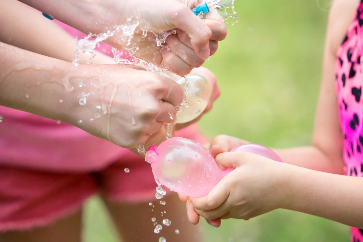 Squeezing and bursting water balloon