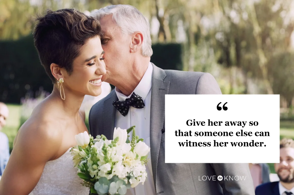 father kissing daughter at her wedding