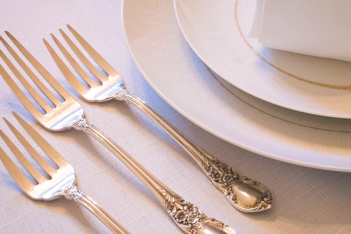 elegant antique silverware place setting