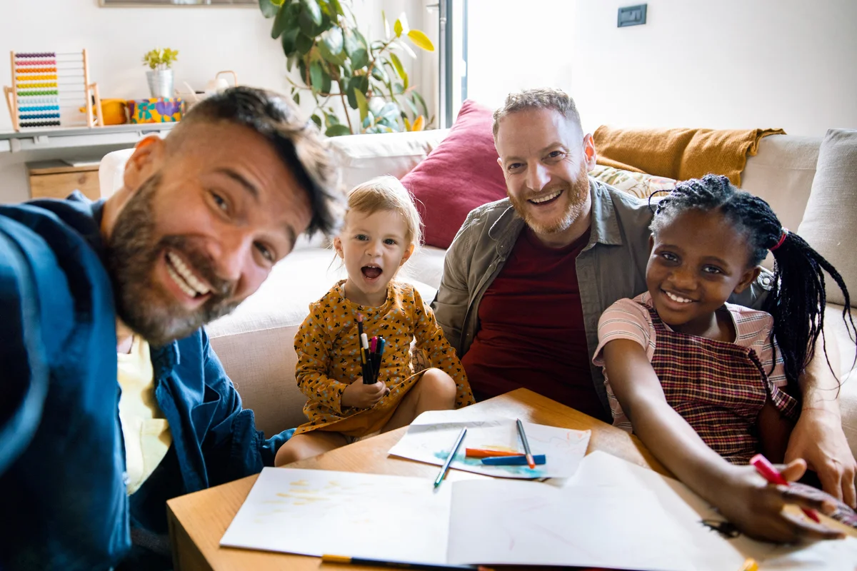 Young family taking a selfie while drawing and coloring