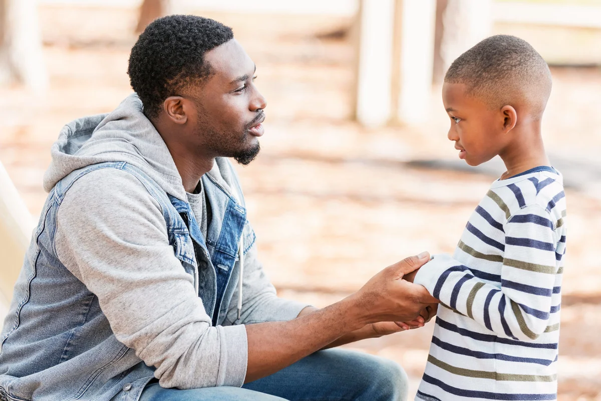 father talking to young son with empathy