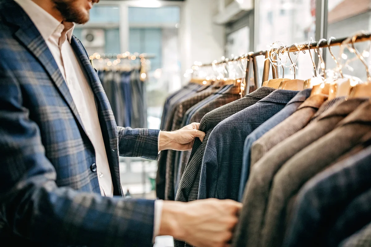 Businessman trying suit in store
