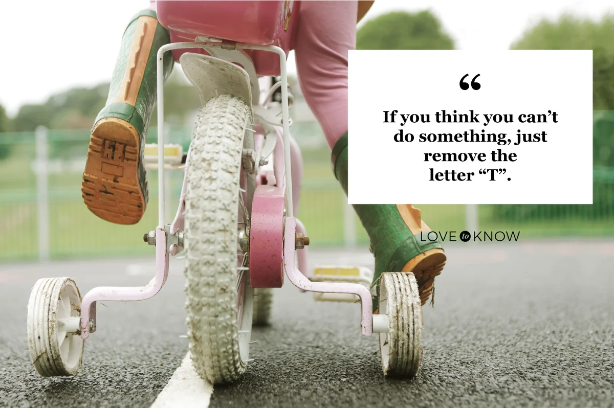 Toddler on bicycle with stabilizers