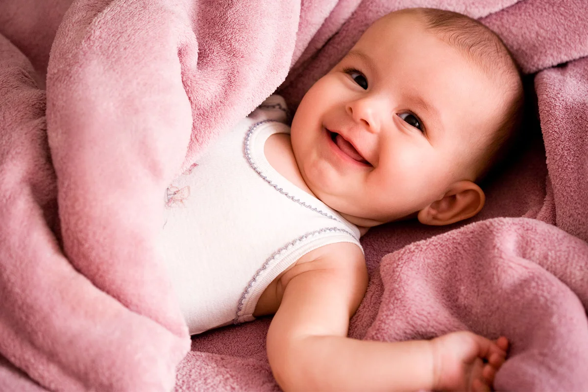 baby girl wrapped in pink blanket