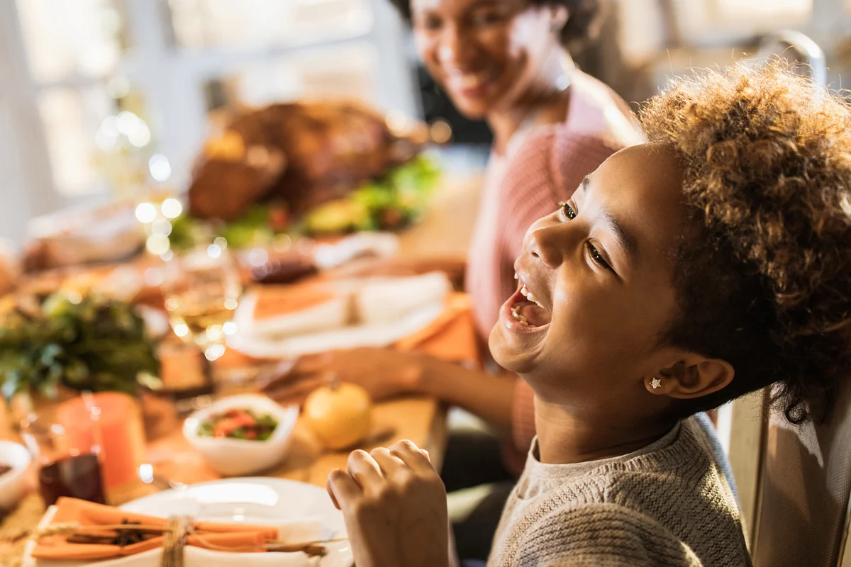 Girl laughing at Thanksgiving table