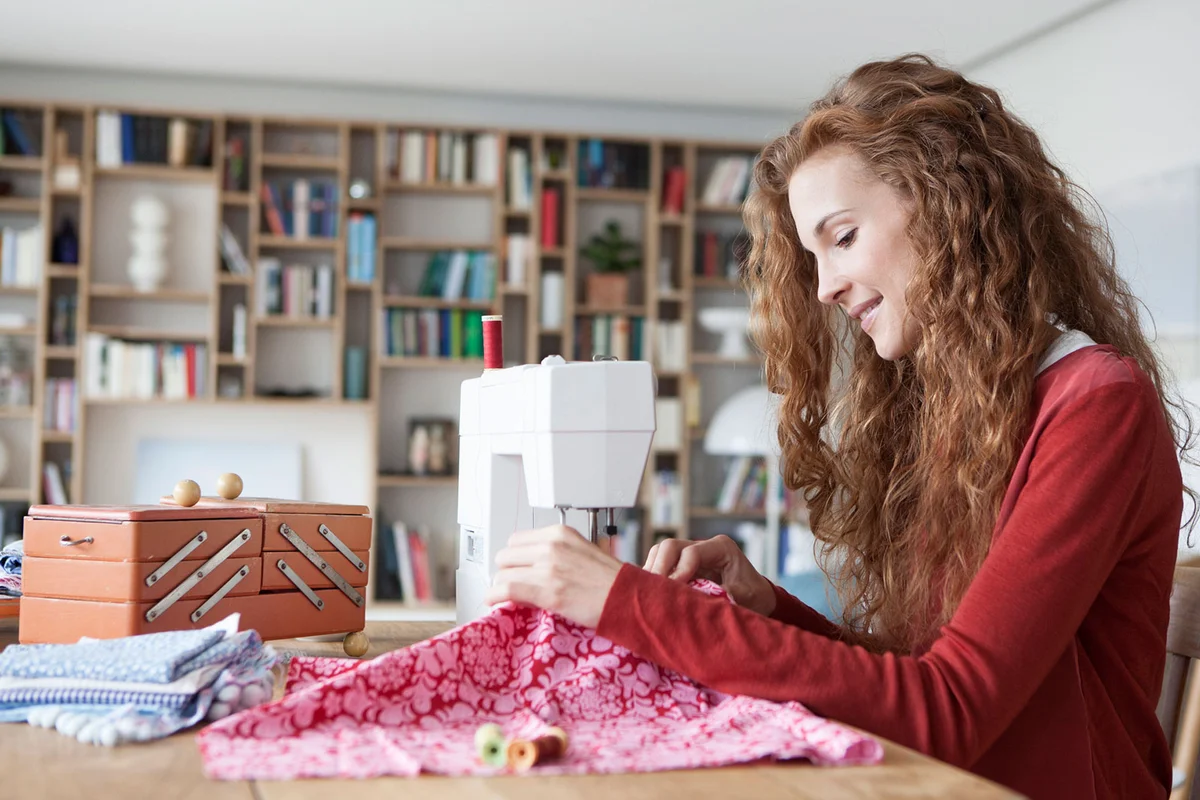 woman using sewing machine