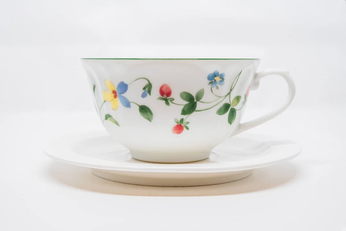 Elegant antique tea cup on white background