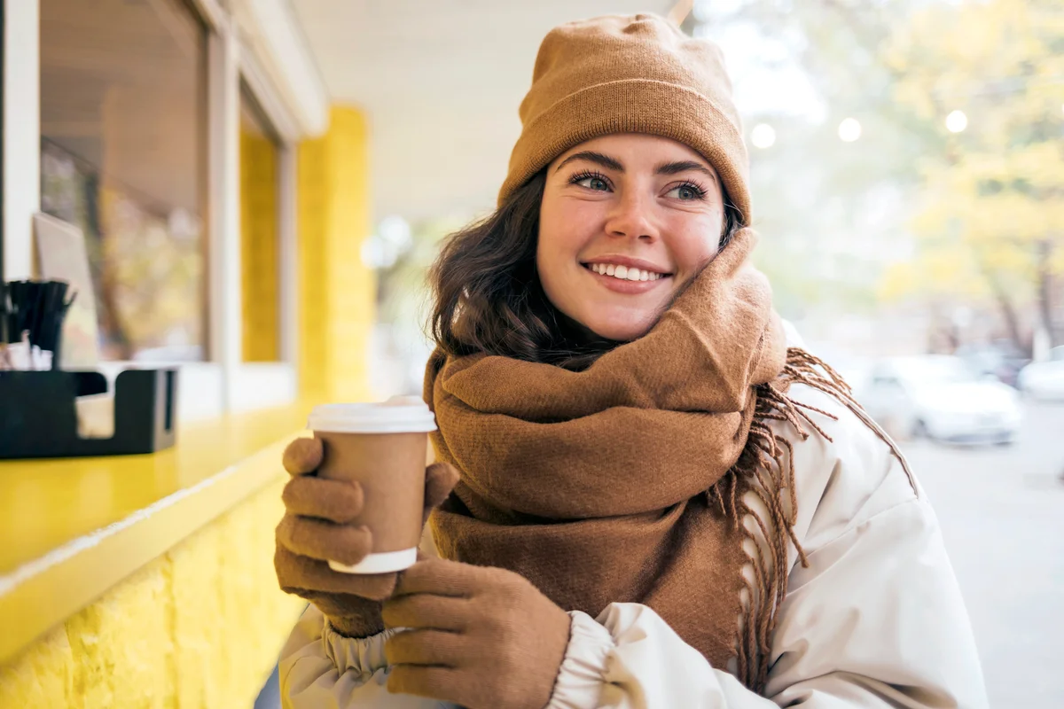 Woman wearing Brown scarf with beanie and gloves matching