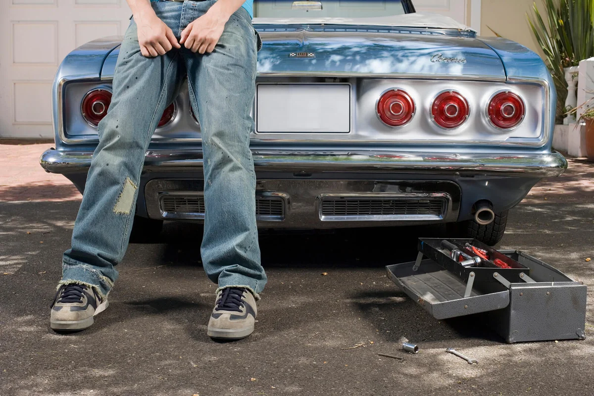 Man Leaning Against Car Trunk