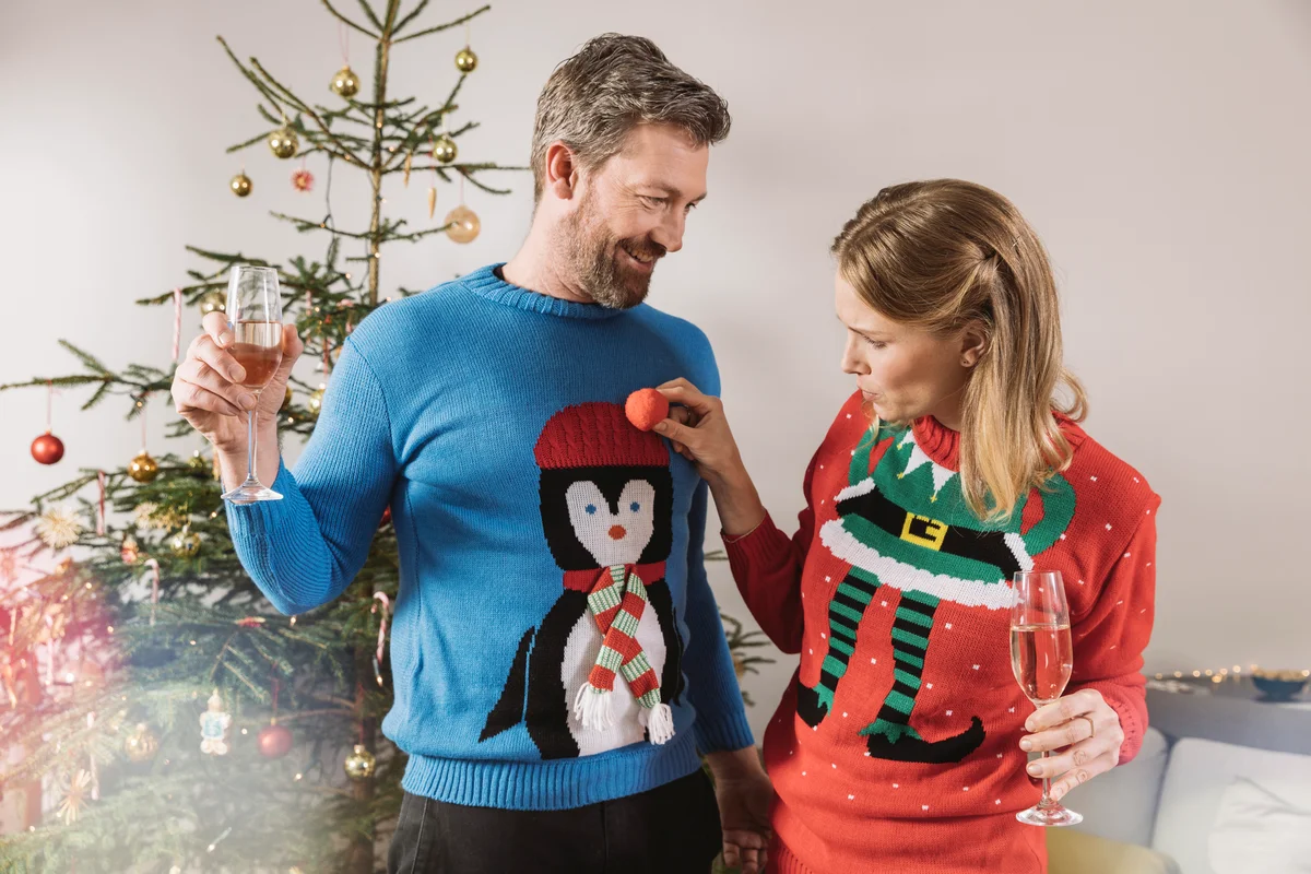 couple wearing ugly Christmas sweaters