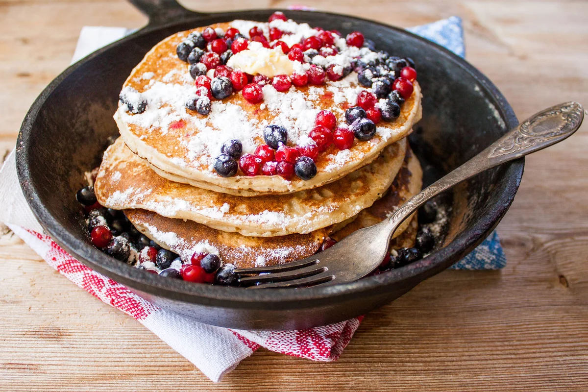 pancakes with berries in cast iron skillet