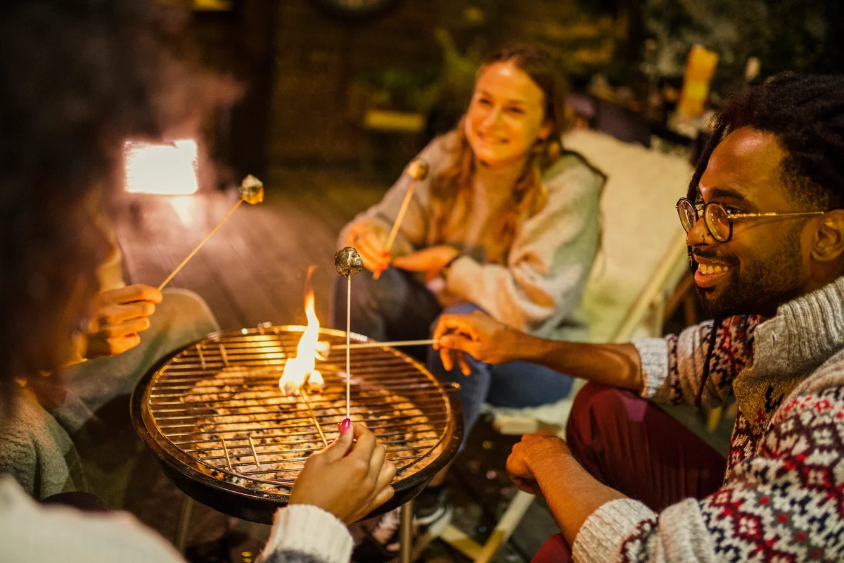 holiday glamping friends roasting marshmallows