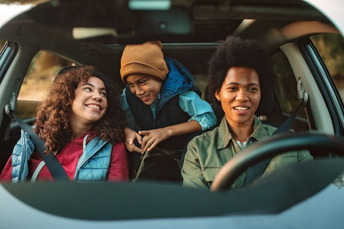 Happy family enjoying their time in a car