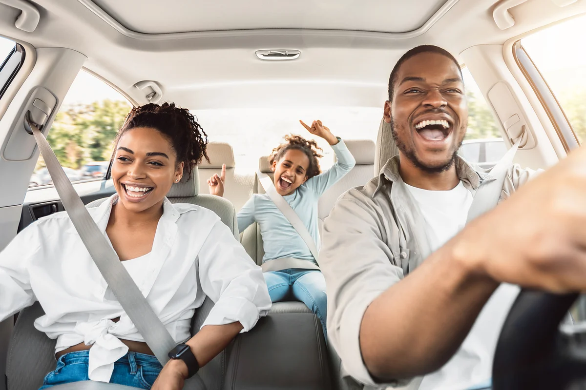 Happy Family Of Three Singing Having Fun Riding Car