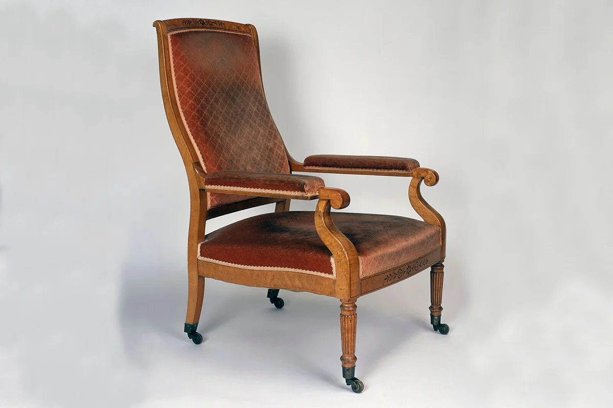 Louis Philippe style clear wood Voltaire armchair on casters | Getty Editorial Use