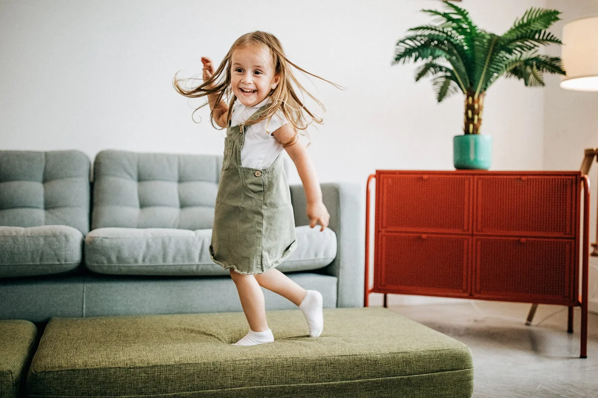 Kid jumping on sofa