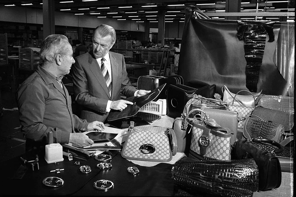 Roberto Gucci talks to one of his employees at a Gucci factory