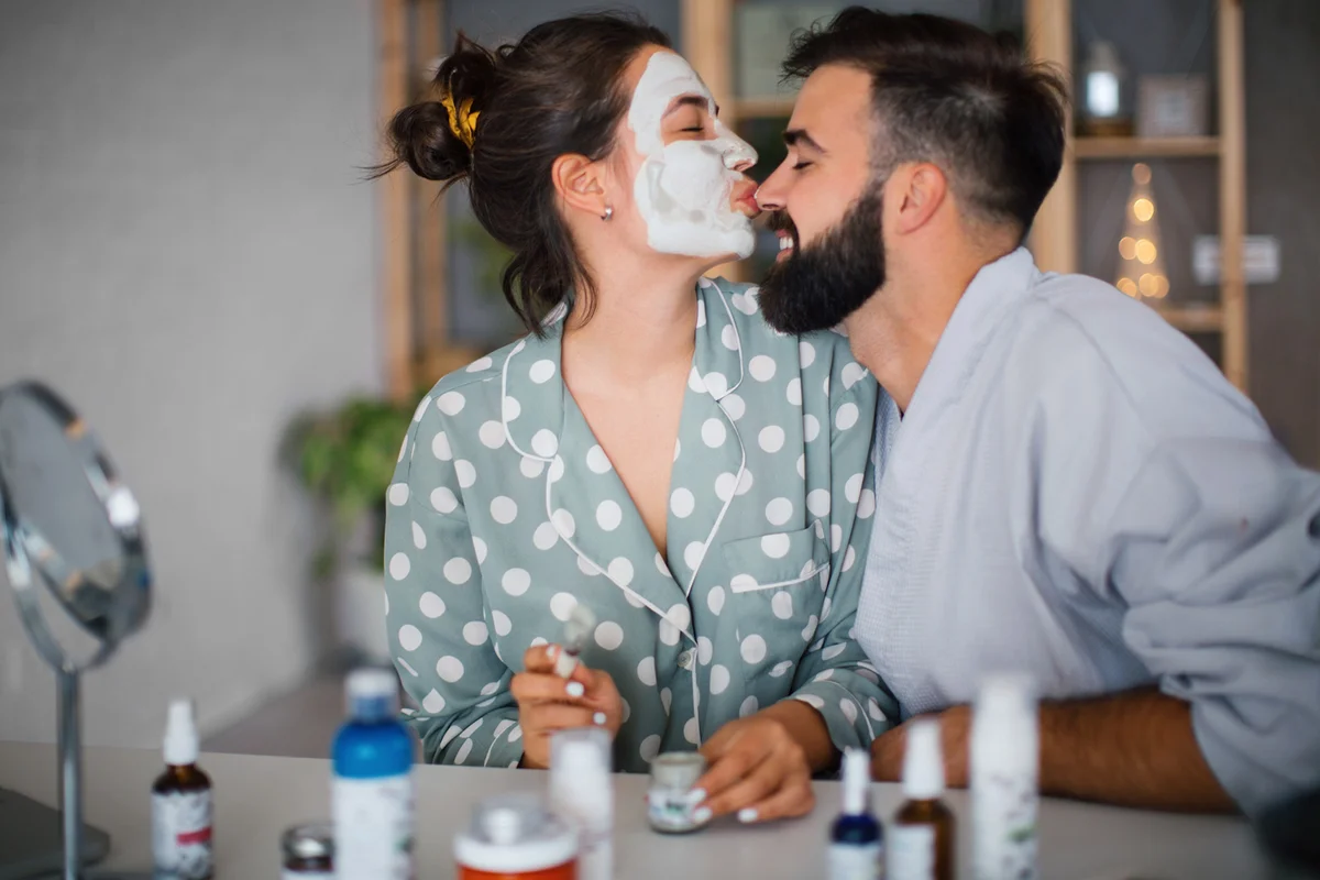 Young couple applying a facial mask to their faces