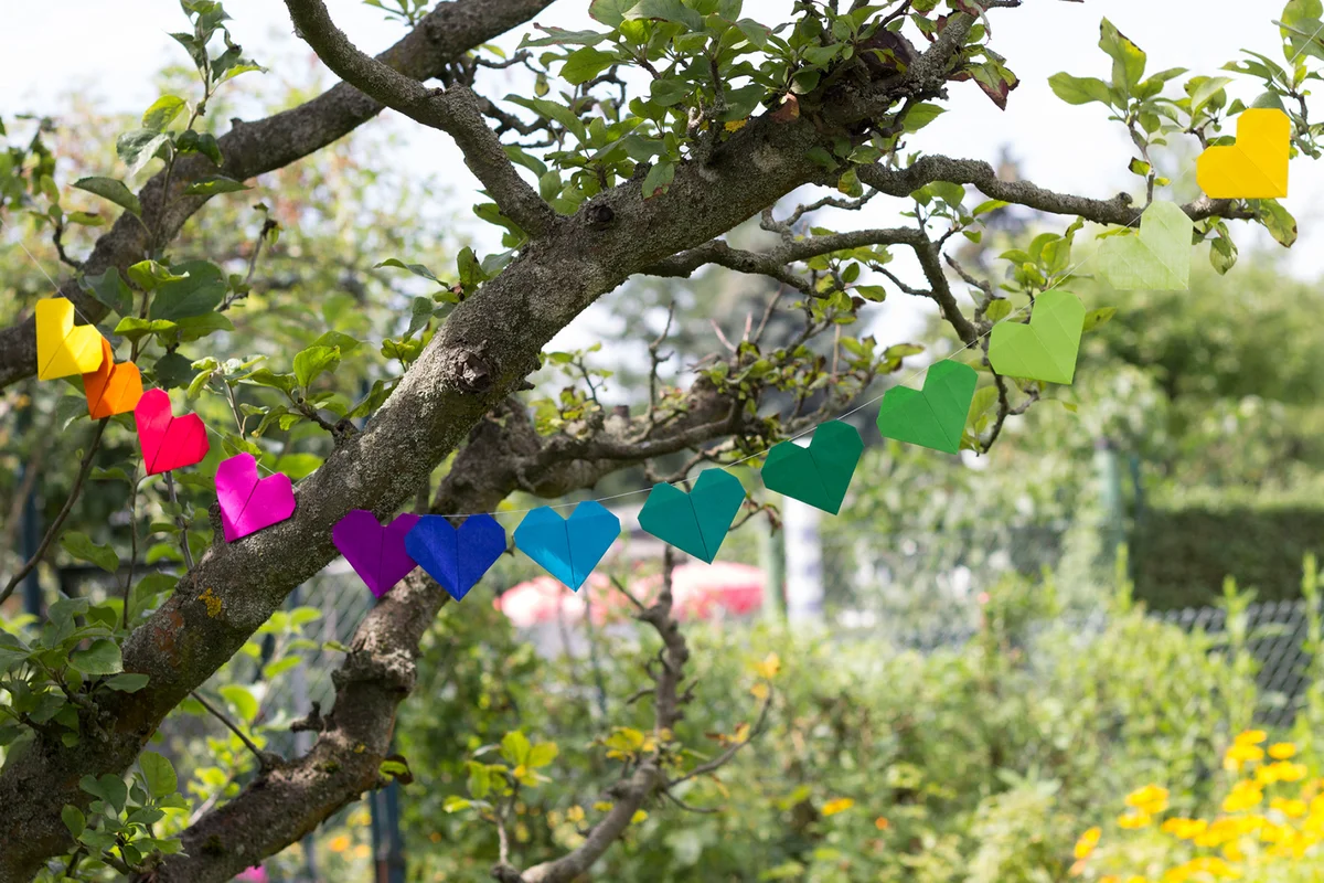 Heart-shaped garland made of paper hanging in garden