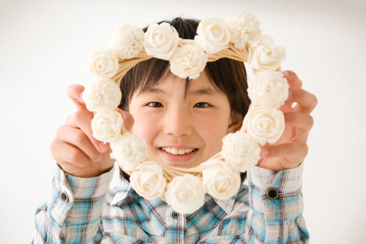 Portrait of girl holding heart-shaped flower wreath