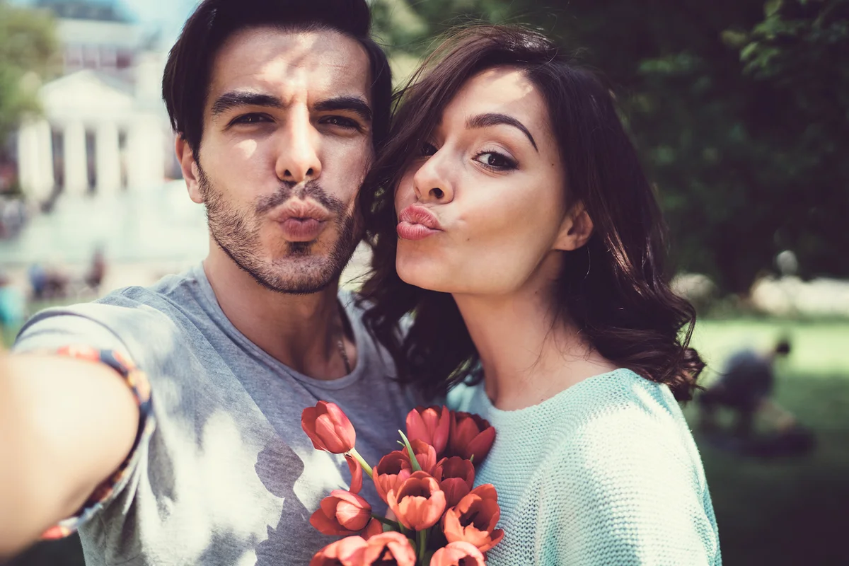 Young couple taking selfie outside