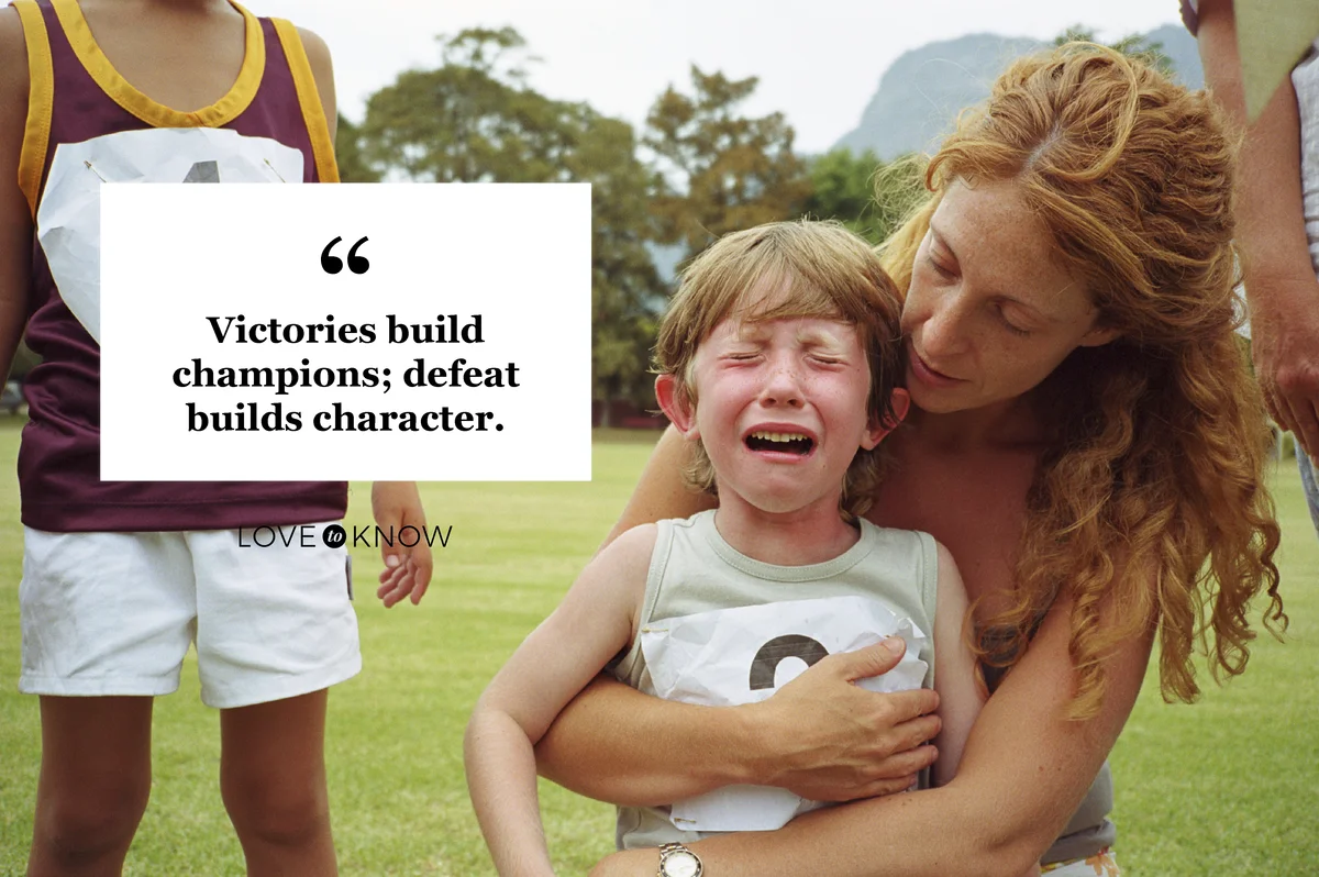 Boy crying while being comforted by mother at school sports day