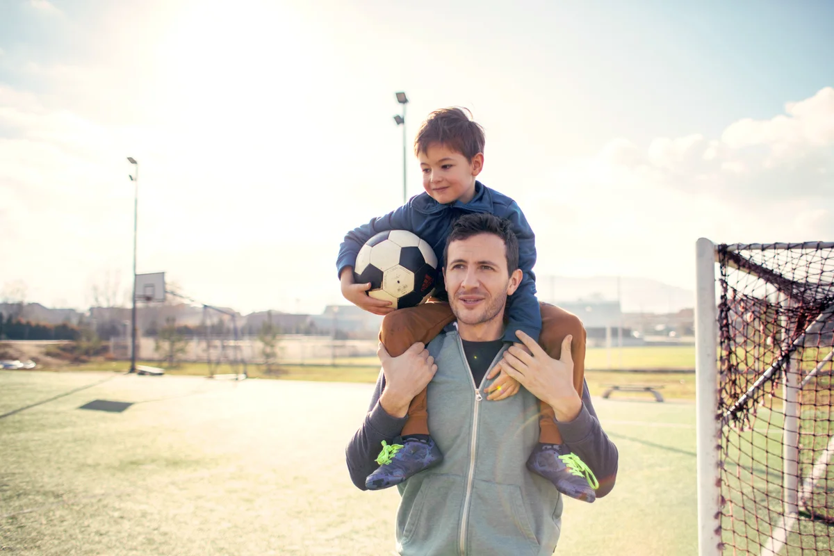Father and son on a soccer court