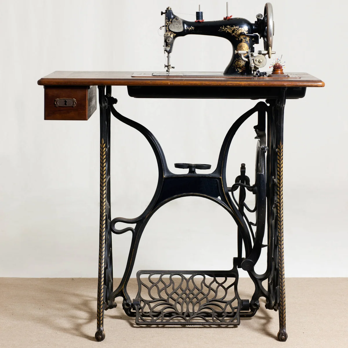 old sewing machine in front of a gray background