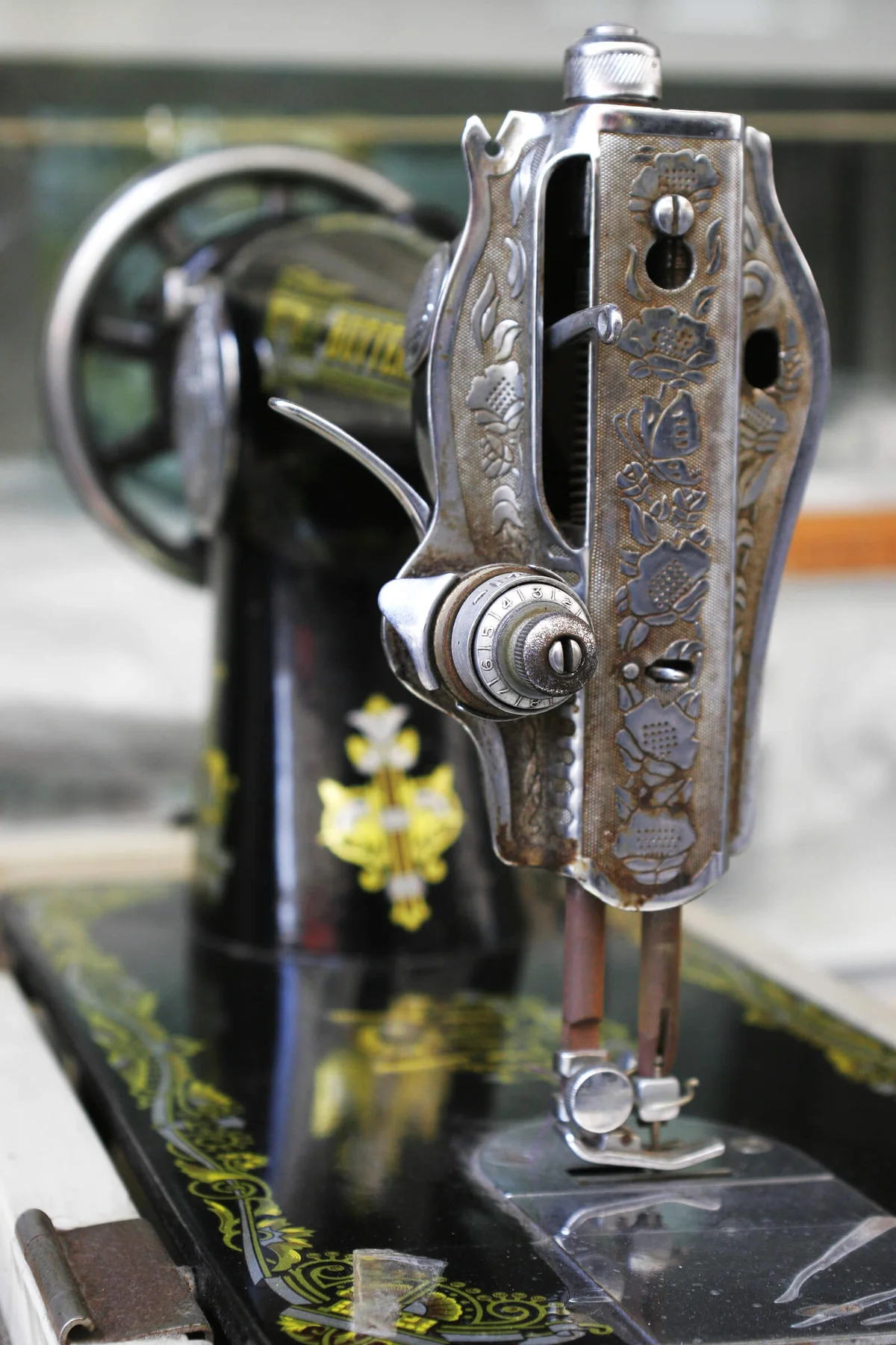 Old sewing machine on display in a market.