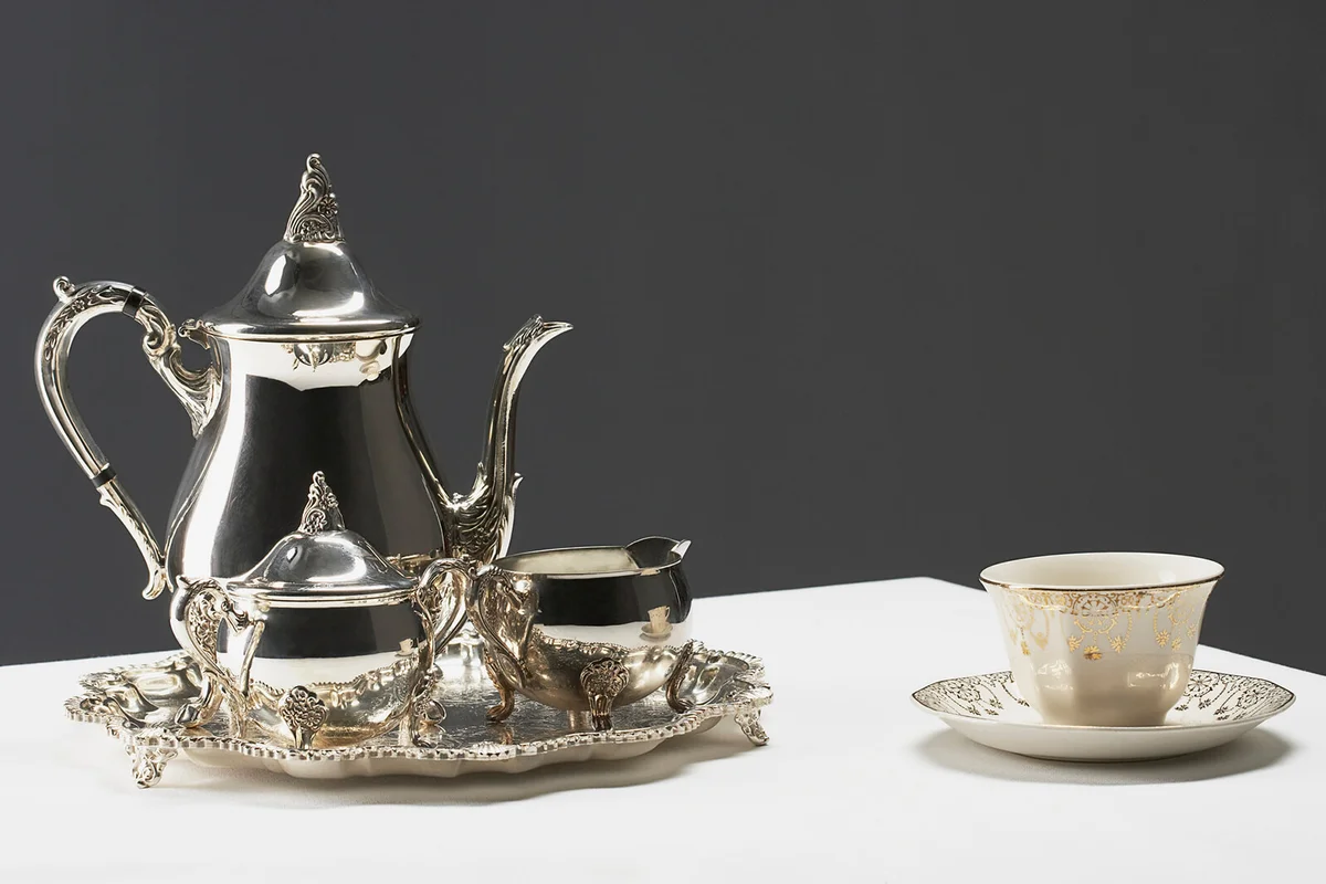 Gilded china tea cup and silver tea set