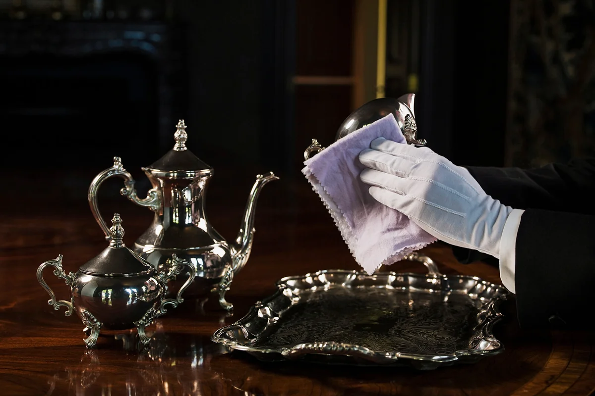 Butler polishing silver serving set