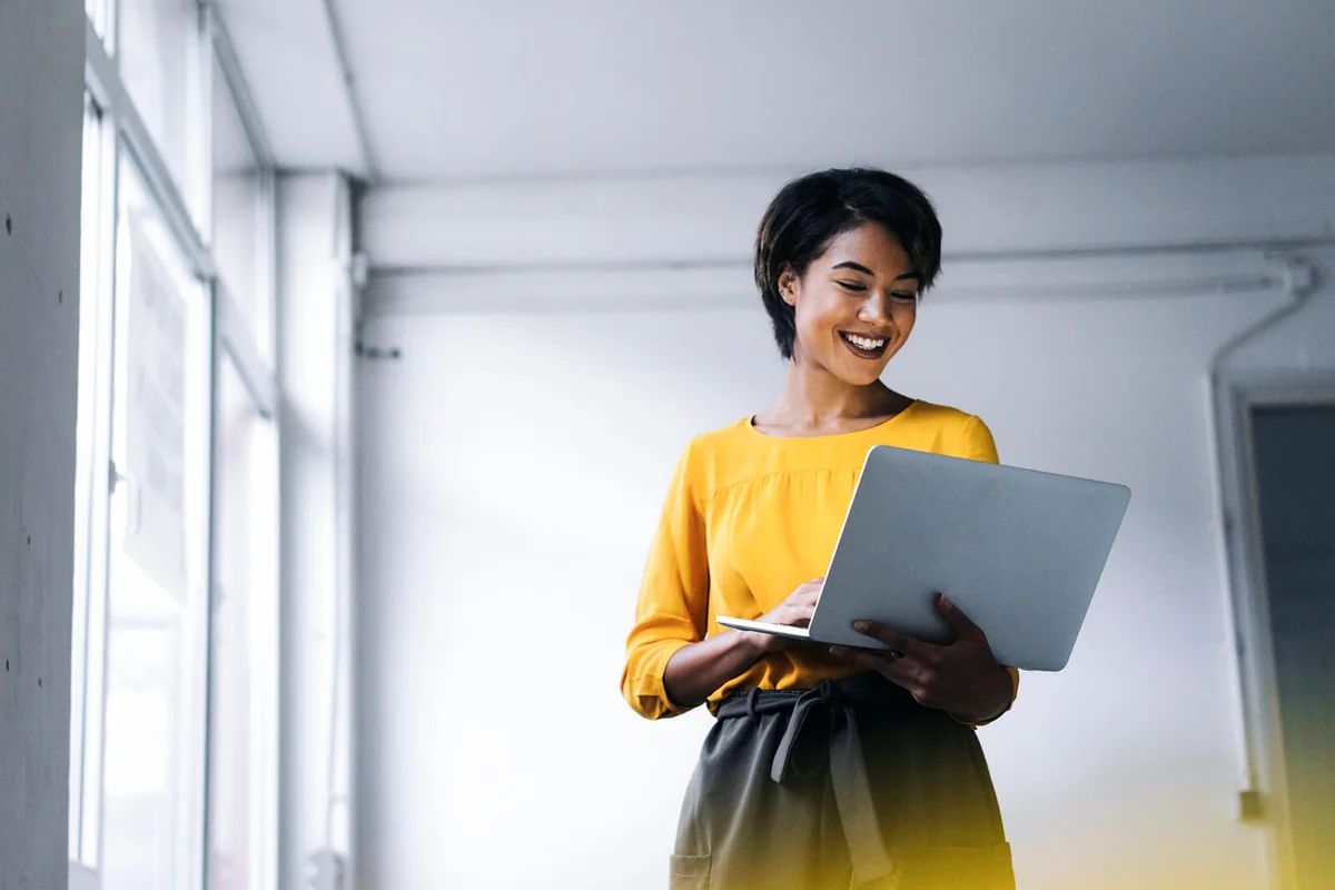 Smiling woman using laptop