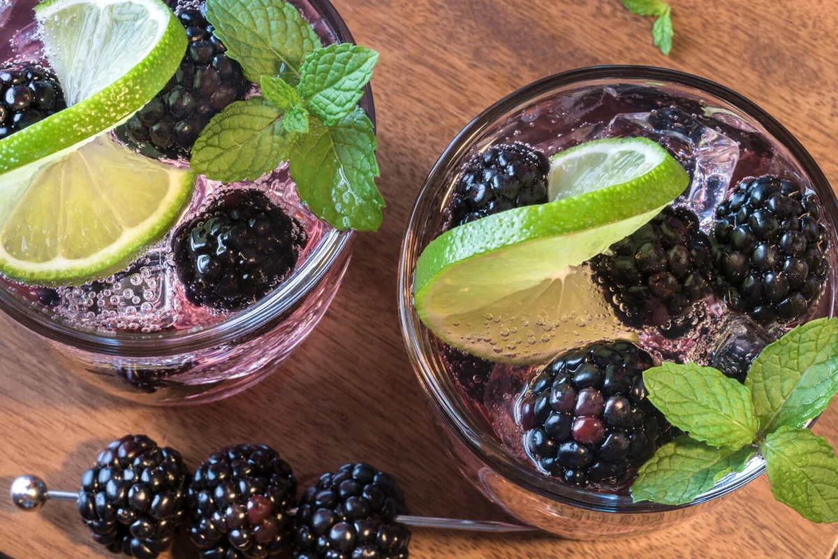 Blackberry Gin With Lemon On Cutting Board