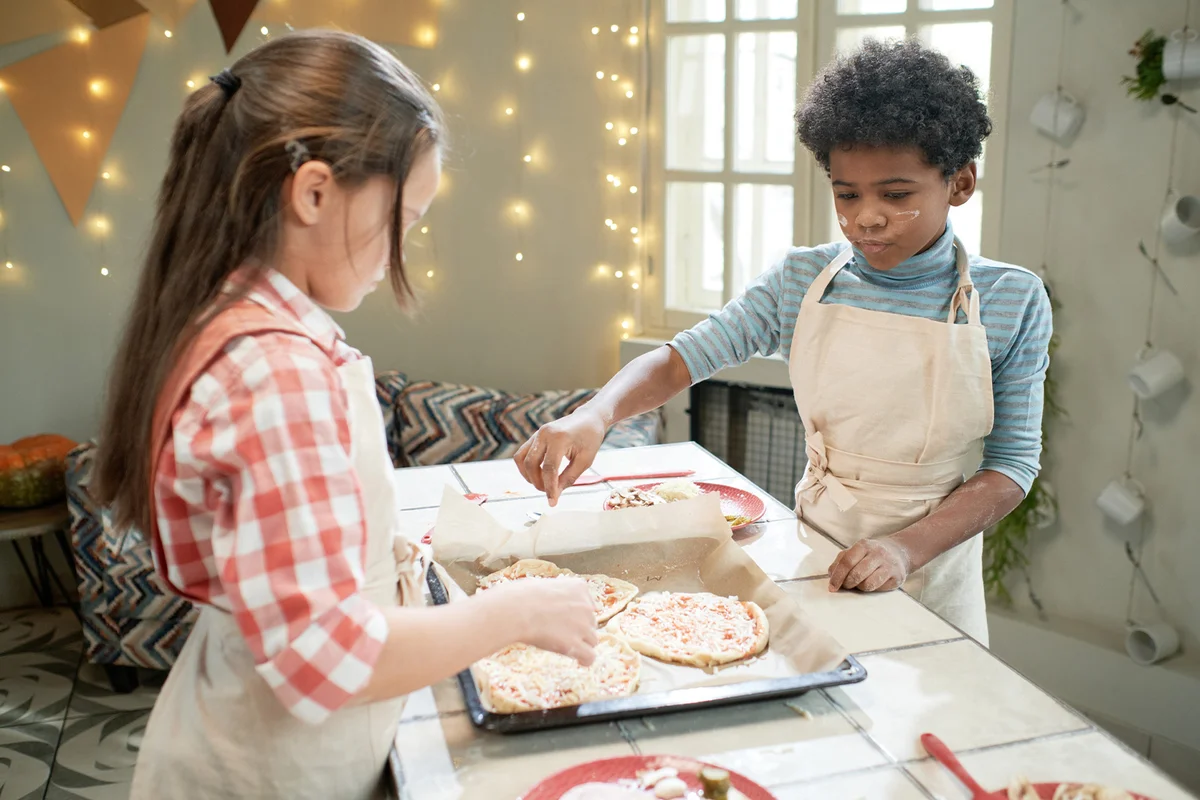 Children making homemade pizza