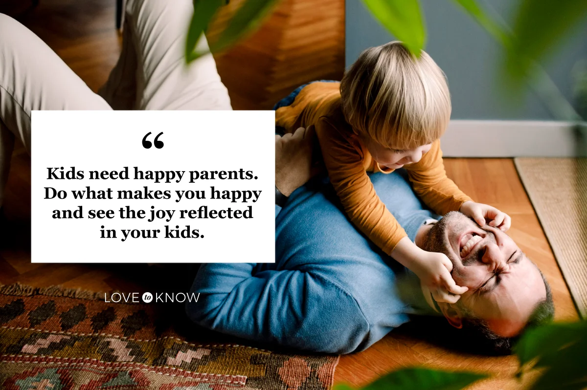 Playful kid pinching cheerful father's cheeks on floor at home