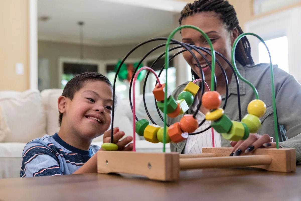 babysitter playing with special needs boy