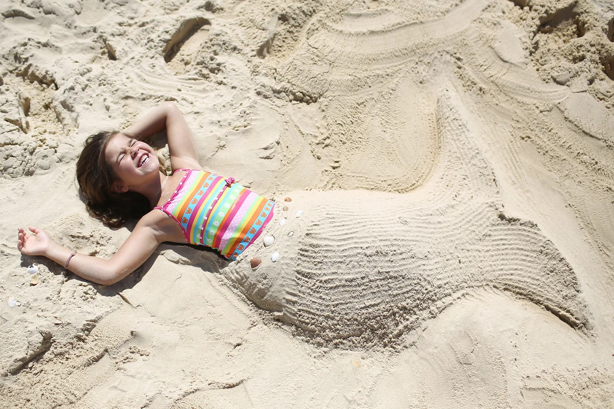 A mermaid girl on the beach