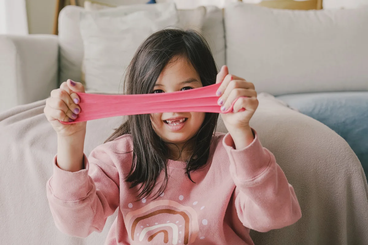 Girl playing with homemade slime at home