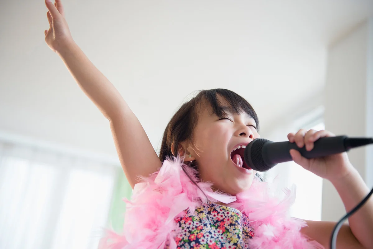 Girl singing karaoke in living room
