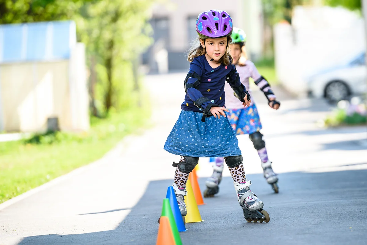 Girl Roller Skating Through Cones On Road