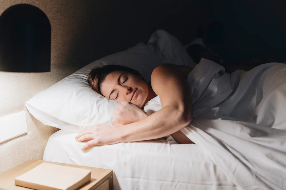 Beautiful woman sleeping on bed in hotel room