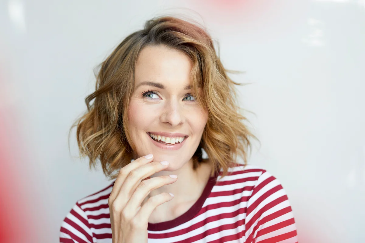 Smiling woman wearing red-white striped t-shirt
