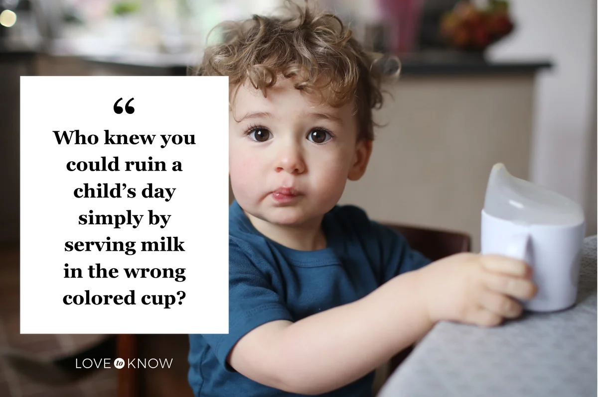 Little boy drinking with a zippy cup in the the kitchen
