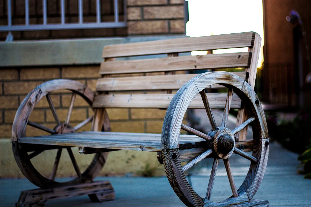 Empty Wooden Bench By Building