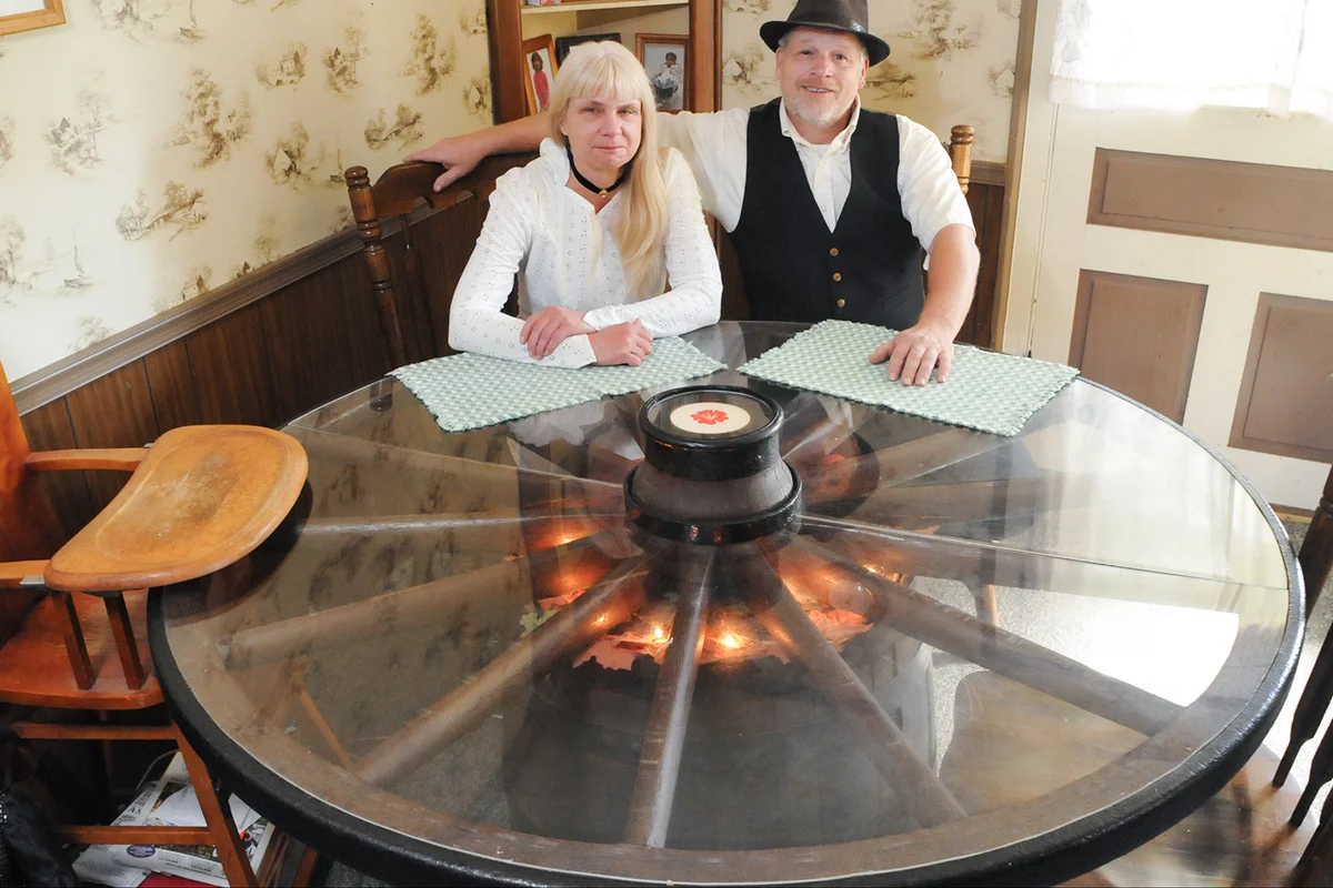 Rick and Cindy Goho Floor PlansPhoto by Bill Uhrich 9/27/2013Rick and Cindy Goho sit at a table Rick made from a barrel and a wagon wheel.